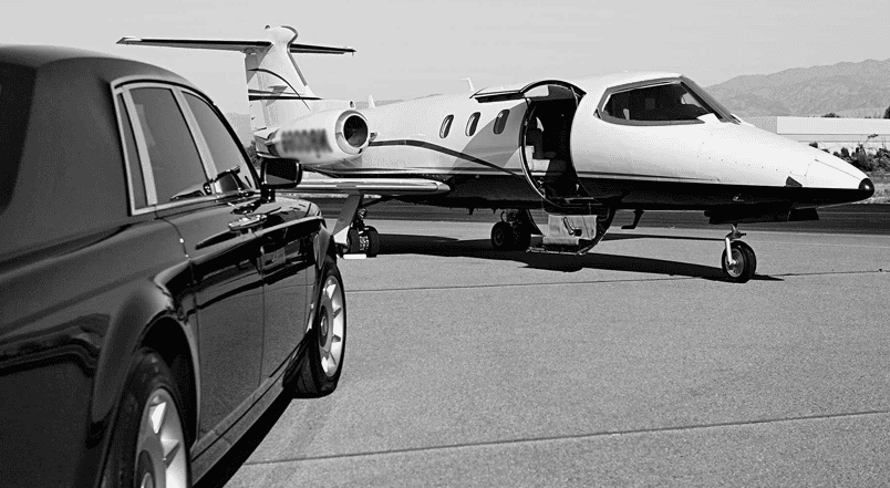 Private jet and luxury vehicle parked on airport runway.